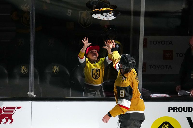 Mar 23, 2024; Las Vegas, Nevada, USA; Vegas Golden Knights center Jack Eichel (9) tosses a souvenir to a fan after being named First Star of the Game in a victory over the Columbus Blue Jackets at T-Mobile Arena. Mandatory Credit: Stephen R. Sylvanie-USA TODAY Sports