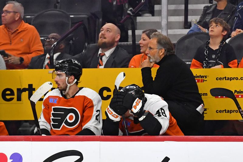 Apr 16, 2024; Philadelphia, Pennsylvania, USA; Philadelphia Flyers left wing Noah Cates (27) and center Morgan Frost (48) on the bench with head coach John Tortorella in the final seconds of loss against the Washington Capitals during the third period at Wells Fargo Center. Mandatory Credit: Eric Hartline-USA TODAY Sports