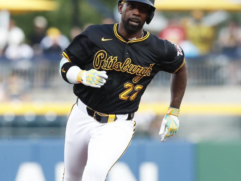 Jun 18, 2024; Pittsburgh, Pennsylvania, USA;  Pittsburgh Pirates designated hitter Andrew McCutchen (22) runs from first base to third base against the Cincinnati Reds during the third inning at PNC Park. Mandatory Credit: Charles LeClaire-USA TODAY Sports