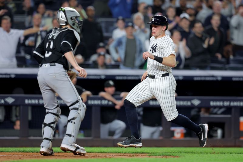 Sep 25, 2025; Bronx, New York, USA; New York Yankees first baseman Ben Rice (22) scores a run against Chicago White Sox catcher Kyle Teel (8) on a double by designated hitter Giancarlo Stanton (not pictured) during the fifth inning at Yankee Stadium. Mandatory Credit: Brad Penner-Imagn Images