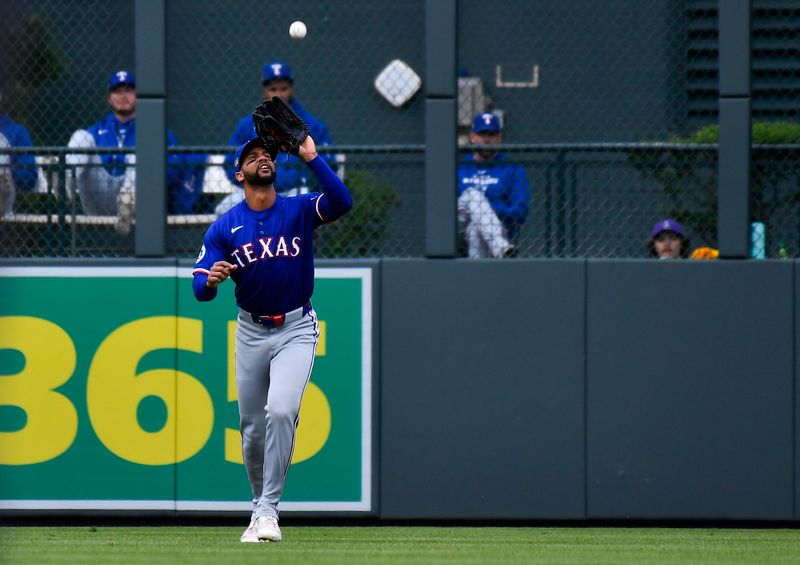 May 11, 2024; Denver, Colorado, USA; Texas Rangers outfielder Leody Taveras (3) catches a fly ball for an out against the Colorado Rockies during the first inning at Coors Field. Mandatory Credit: John Leyba-USA TODAY Sports