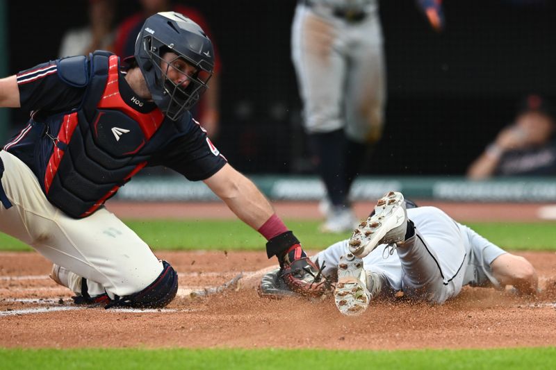 Jul 22, 2024; Cleveland, Ohio, USA; Detroit Tigers catcher Jake Rogers (34) scores past the tag of Cleveland Guardians catcher Austin Hedges (27) during the second inning at Progressive Field. Mandatory Credit: Ken Blaze-USA TODAY Sports