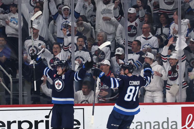 Apr 21, 2025; Winnipeg, Manitoba, CAN;Winnipeg Jets center Mark Scheifele (55) celebrates a goal against the St. Louis Blues with Winnipeg Jets left wing Kyle Connor (81) in the first period in game two of the first round of the 2025 Stanley Cup Playoffs at Canada Life Centre. Mandatory Credit: James Carey Lauder-Imagn Images