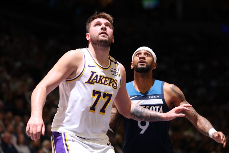 MINNEAPOLIS, MN -  APRIL  27:  Luka Doncic #77 of the Los Angeles Lakers and Nickeil Alexander-Walker #9 of the Minnesota Timberwolves boxes out during the game during Round 1 Game 4 of the 2025 NBA Playoffs  on April 27, 2025 at Target Center in Minneapolis, Minnesota. NOTE TO USER: User expressly acknowledges and agrees that, by downloading and or using this Photograph, user is consenting to the terms and conditions of the Getty Images License Agreement. Mandatory Copyright Notice: Copyright 2025 NBAE (Photo by David Sherman/NBAE via Getty Images)
