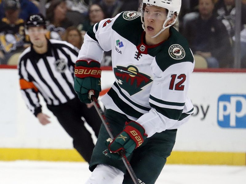 Apr 6, 2023; Pittsburgh, Pennsylvania, USA; Minnesota Wild left wing Matt Boldy (12) skates up ice with the puck against the Pittsburgh Penguins during the first period at PPG Paints Arena. Mandatory Credit: Charles LeClaire-USA TODAY Sports