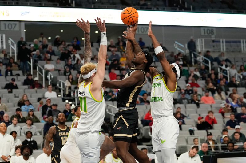 Mar 16, 2024; Fort Worth, TX, USA; UAB Blazers guard Alejandro Vasquez (10) scores a basket between South Florida Bulls forward Kasean Pryor (11) and guard Selton Miguel (1) during the first half at Dickies Arena. Mandatory Credit: Chris Jones-USA TODAY Sports