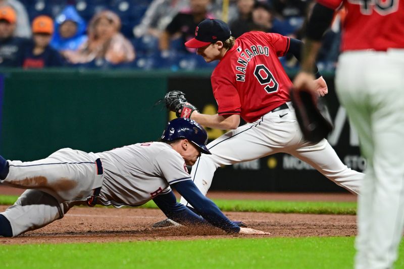 Sep 28, 2024; Cleveland, Ohio, USA; Cleveland Guardians first baseman Kyle Manzardo (9) forces out Houston Astros designated hitter Zach Dezenzo (9) during the ninth inning at Progressive Field. Mandatory Credit: Ken Blaze-Imagn Images