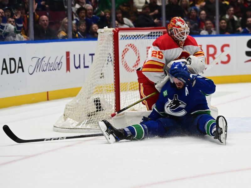 Mar 23, 2024; Vancouver, British Columbia, CAN; Vancouver Canucks forward J.T. Miller (9) slides into Calgary Flames goaltender Jacob Markstrom (25) during the third period at Rogers Arena. Mandatory Credit: Simon Fearn-USA TODAY Sports