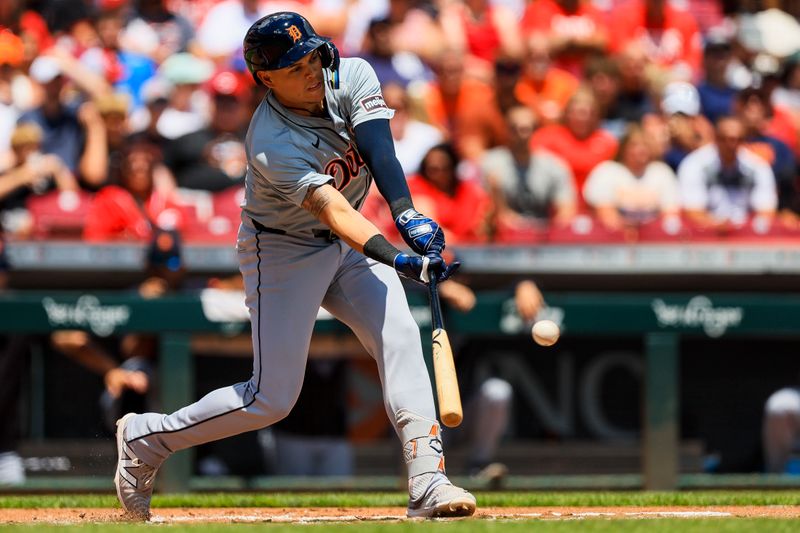 Jul 7, 2024; Cincinnati, Ohio, USA; Detroit Tigers third baseman Gio Urshela (13) hits a single against the Cincinnati Reds in the second inning at Great American Ball Park. Mandatory Credit: Katie Stratman-USA TODAY Sports