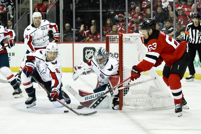 Oct 19, 2024; Newark, New Jersey, USA; New Jersey Devils left wing Jesper Bratt (63) has a shot attempt deflected by Washington Capitals defenseman Jakob Chychrun (6) and Washington Capitals goaltender Logan Thompson (48) during the second period at Prudential Center. Mandatory Credit: John Jones-Imagn Images