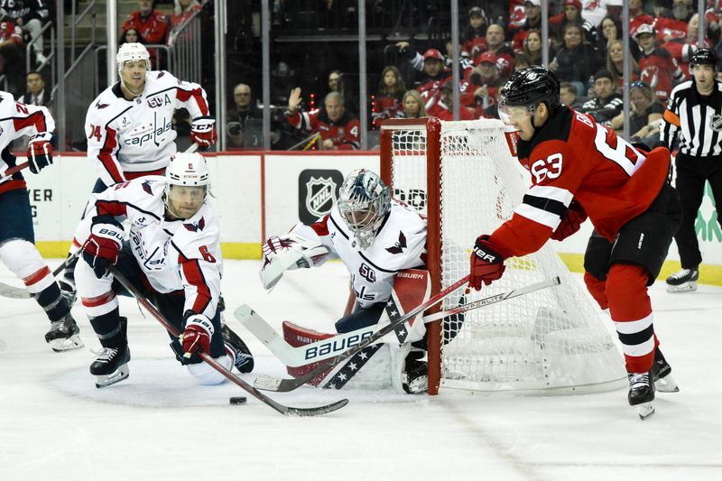 Oct 19, 2024; Newark, New Jersey, USA; New Jersey Devils left wing Jesper Bratt (63) has a shot attempt deflected by Washington Capitals defenseman Jakob Chychrun (6) and Washington Capitals goaltender Logan Thompson (48) during the second period at Prudential Center. Mandatory Credit: John Jones-Imagn Images