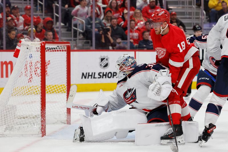 Nov 11, 2023; Detroit, Michigan, USA;  Columbus Blue Jackets goaltender Spencer Martin (30) makes a save in front of Detroit Red Wings center Andrew Copp (18) in the second period at Little Caesars Arena. Mandatory Credit: Rick Osentoski-USA TODAY Sports