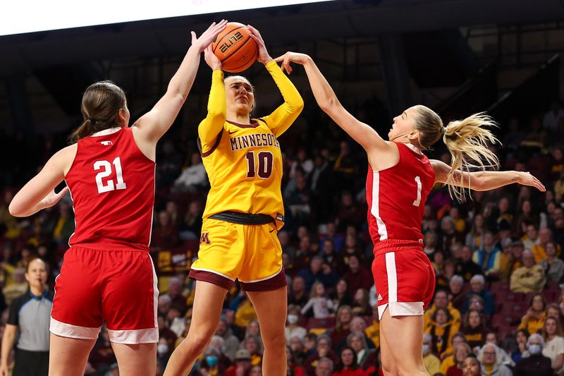 Jan 14, 2024; Minneapolis, Minnesota, USA; Minnesota Golden Gophers guard Mara Braun (10) shoots as Nebraska Cornhuskers forward Annika Stewart (21) and guard Jaz Shelley (1) defend during the first half at Williams Arena. Mandatory Credit: Matt Krohn-USA TODAY Sports