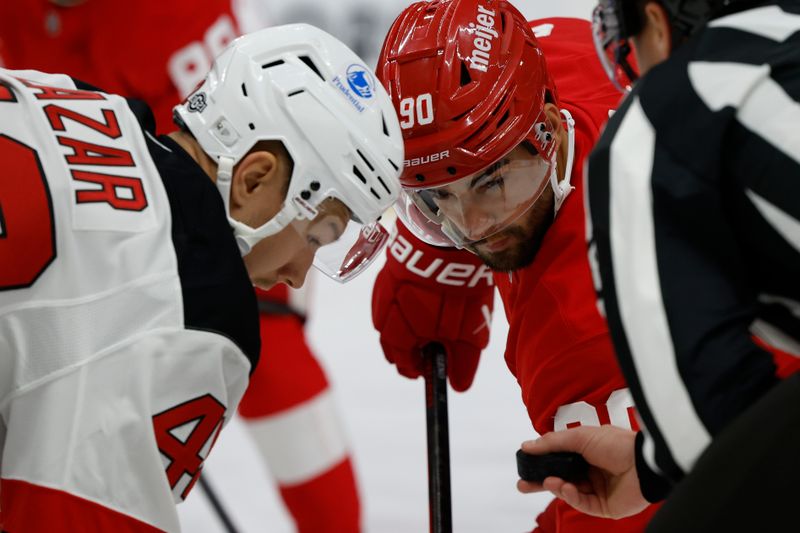 Oct 24, 2024; Detroit, Michigan, USA;  Detroit Red Wings center Joe Veleno (90) and New Jersey Devils center Curtis Lazar (42) gets set to face off in the second period at Little Caesars Arena. Mandatory Credit: Rick Osentoski-Imagn Images