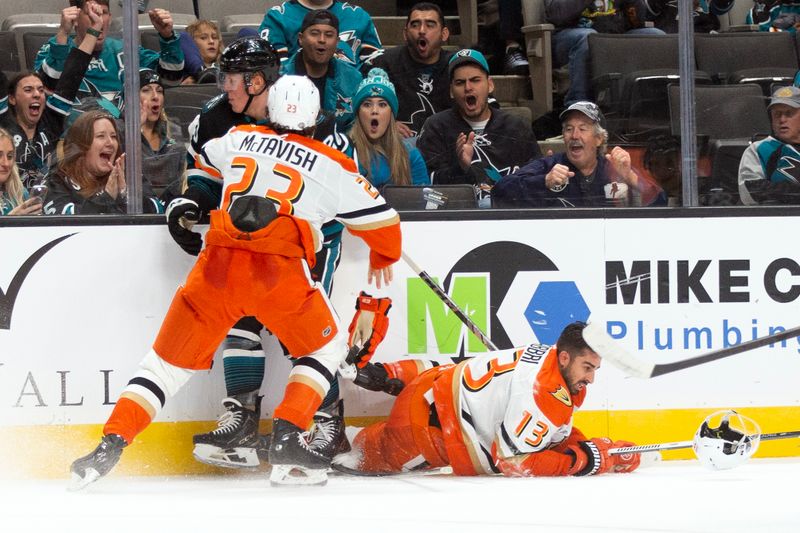 Oct 12, 2024; San Jose, California, USA; Anaheim Ducks center Robby Fabbri (13) loses his helmet as center Mason McTavish (23) and San Jose Sharks left winger Fabian Zetterlund (20) mix it up during the second period at SAP Center at San Jose. Mandatory Credit: D. Ross Cameron-Imagn Images