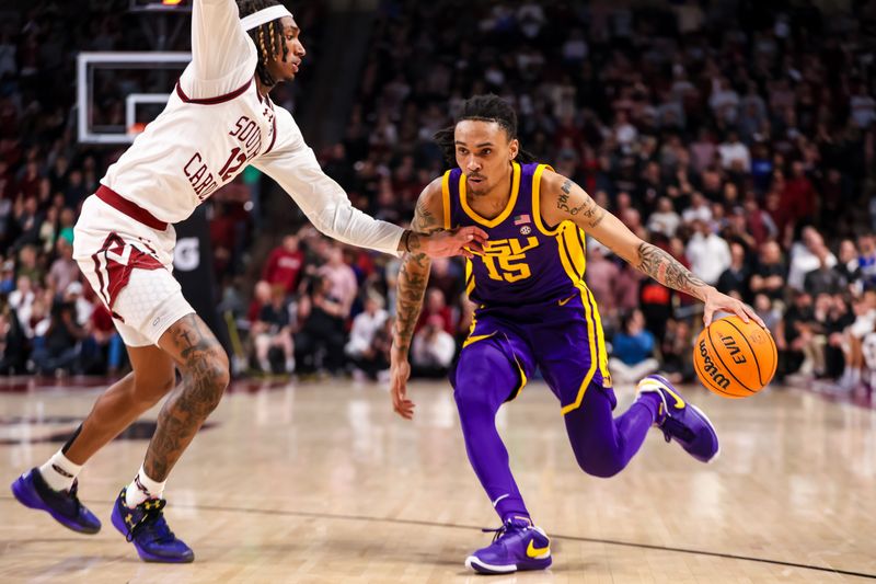 Feb 17, 2024; Columbia, South Carolina, USA; LSU Tigers forward Tyrell Ward (15) drives around South Carolina Gamecocks guard Zachary Davis (12) in the second half at Colonial Life Arena. Mandatory Credit: Jeff Blake-USA TODAY Sports