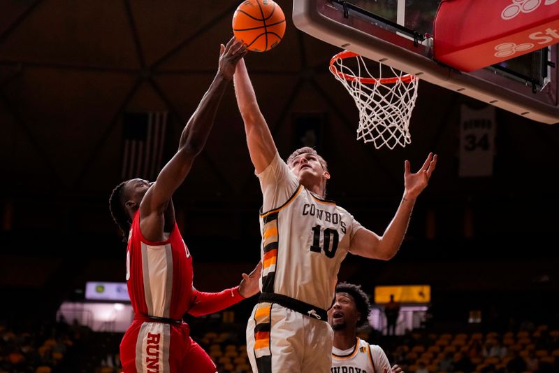 Feb 8, 2023; Laramie, Wyoming, USA; Wyoming Cowboys forward Hunter Thompson (10) battles UNLV Runnin' Rebels forward Victor Iwuakor (0) for a rebound during the first half at Arena-Auditorium. Mandatory Credit: Troy Babbitt-USA TODAY Sports