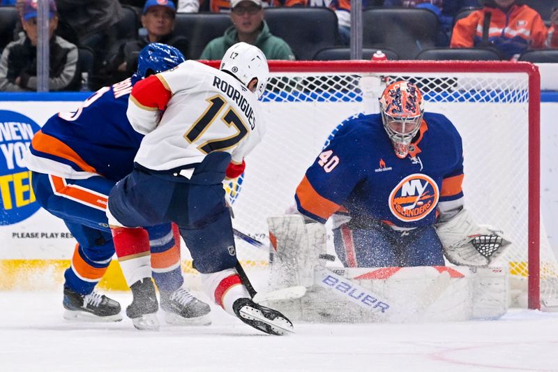 Oct 26, 2024; Elmont, New York, USA;  New York Islanders goaltender Semyon Varlamov (40) makes a save on Florida Panthers center Evan Rodrigues (17) during the second period at UBS Arena. Mandatory Credit: Dennis Schneidler-Imagn Images