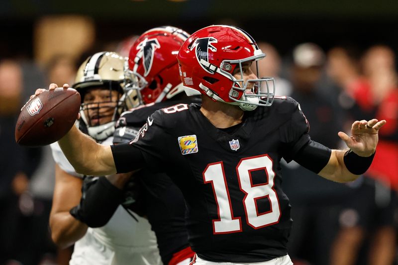 Atlanta Falcons quarterback Kirk Cousins (18) works against the New Orleans Saints during the first half of an NFL football game, Sunday, Sept. 29, 2024, in Atlanta. (AP Photo/Butch Dill)