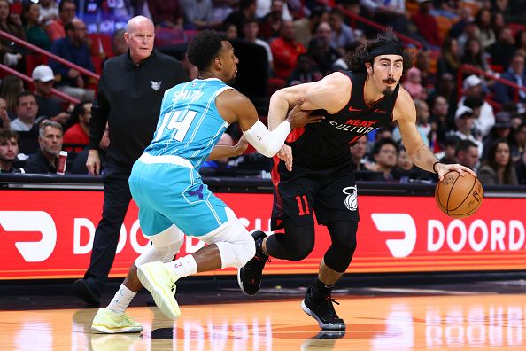 MIAMI, FLORIDA - DECEMBER 13: Jaime Jaquez Jr. #11 of the Miami Heat drives to the basket against Ish Smith #14 of the Charlotte Hornets during the first quarter of the game at Kaseya Center on December 13, 2023 in Miami, Florida. NOTE TO USER: User expressly acknowledges and agrees that, by downloading and or using this photograph, User is consenting to the terms and conditions of the Getty Images License Agreement. (Photo by Megan Briggs/Getty Images)