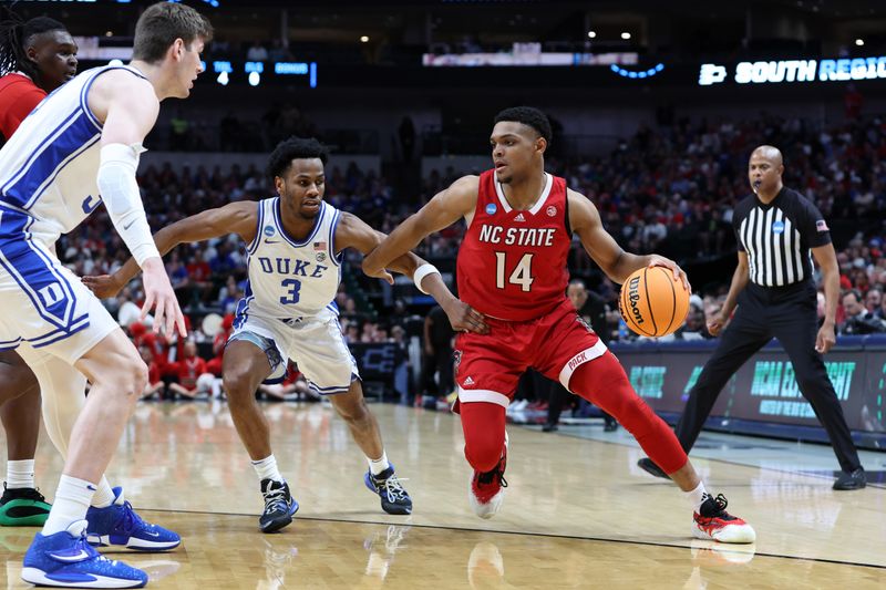 Mar 31, 2024; Dallas, TX, USA; North Carolina State Wolfpack guard Casey Morsell (14) controls the ball against Duke Blue Devils guard Jeremy Roach (3) in the first half in the finals of the South Regional of the 2024 NCAA Tournament at American Airline Center. Mandatory Credit: Tim Heitman-USA TODAY Sports