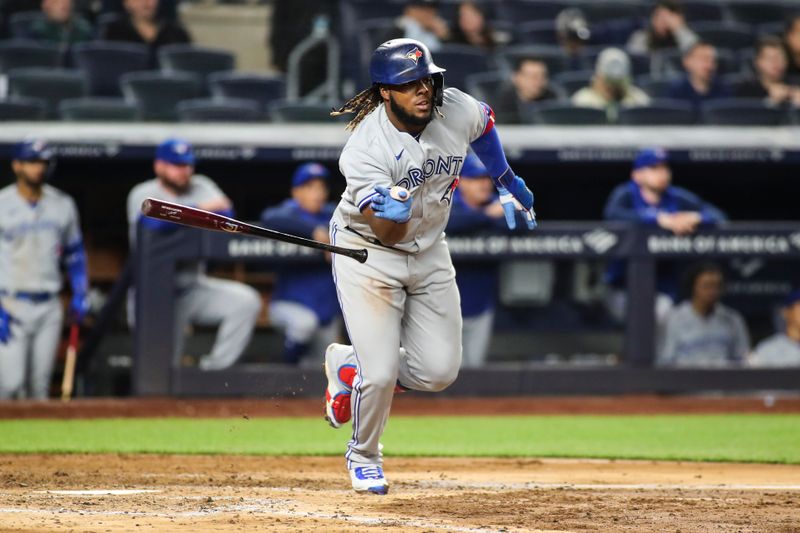 Apr 13, 2022; Bronx, New York, USA;  Toronto Blue Jays first baseman Vladimir Guerrero Jr. (27) hits a double in the sixth inning against the New York Yankees at Yankee Stadium. Mandatory Credit: Wendell Cruz-USA TODAY Sports