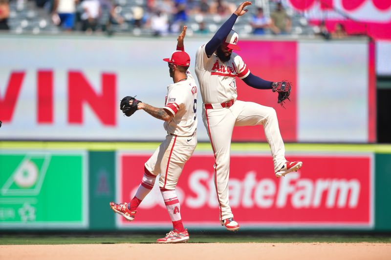 Jul 14, 2024; Anaheim, California, USA; Los Angeles Angels shortstop Zach Neto (9) and right fielder Jo Adell (7) celebrate the victory against the Seattle Mariners at Angel Stadium. Mandatory Credit: Gary A. Vasquez-USA TODAY Sports