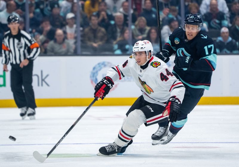 Nov 14, 2024; Seattle, Washington, USA;  Chicago Blackhawks defenseman Wyatt Kaiser (44) skates against Seattle Kraken forward Jaden Schwartz (17) during the first period at Climate Pledge Arena. Mandatory Credit: Stephen Brashear-Imagn Images