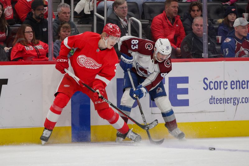 Mar 18, 2023; Detroit, Michigan, USA; Detroit Red Wings defenseman Simon Edvinsson (3) and Colorado Avalanche left wing Matt Nieto (83) fight for control of the puck during the first period at Little Caesars Arena. Mandatory Credit: Brian Bradshaw Sevald-USA TODAY Sports