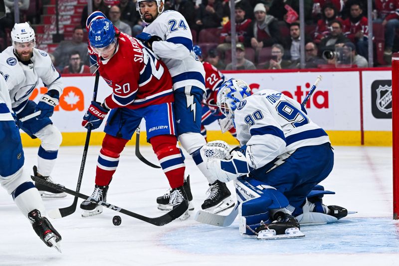 Apr 4, 2024; Montreal, Quebec, CAN; Montreal Canadiens left wing Juraj Slafkovsky (20) shoots the puck on Tampa Bay Lightning goalie Matt Tomkins (90) during the third period at Bell Centre. Mandatory Credit: David Kirouac-USA TODAY Sports