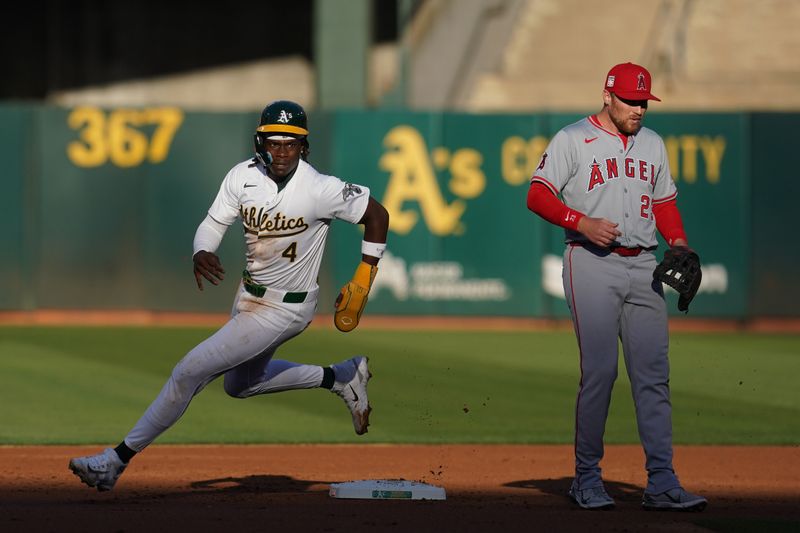 Jul 19, 2024; Oakland, California, USA; Oakland Athletics right fielder Lawrence Butler (4) rounds second base next to Los Angeles Angels second baseman Brandon Drury (23) in the first inning at Oakland-Alameda County Coliseum. Mandatory Credit: Cary Edmondson-USA TODAY Sports