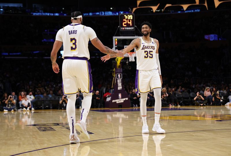 LOS ANGELES, CALIFORNIA - OCTOBER 15: Anthony Davis #3 of the Los Angeles Lakers is congratulated by Christian Wood #35 after scoring a basket and drawing a foul against Jae Crowder #99 of the Milwaukee Bucks during first half of a preseason basketball game at Crypto.com Arena on October 15, 2023 in Los Angeles, California. NOTE TO USER: User expressly acknowledges and agrees that, by downloading and or using this photograph, User is consenting to the terms and conditions of the Getty Images License Agreement. (Photo by Kevork Djansezian/Getty Images)