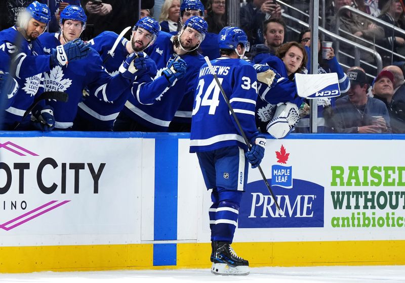 Oct 19, 2024; Toronto, Ontario, CAN; Toronto Maple Leafs center Auston Matthews (34) celebrates with teammates after scoring a goal against the New York Rangers during the third  period at Scotiabank Arena. Mandatory Credit: Nick Turchiaro-Imagn Images