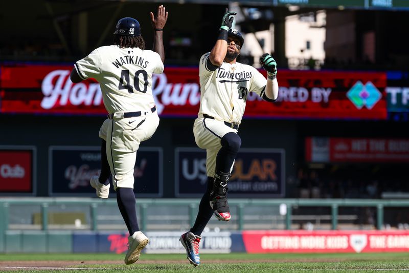 Sep 29, 2024; Minneapolis, Minnesota, USA; Minnesota Twins first baseman Carlos Santana (30) celebrates his solo home run with third base coach Tommy Watkins (40) as he runs the bases during the second inning against the Baltimore Orioles at Target Field. Mandatory Credit: Matt Krohn-Imagn Images