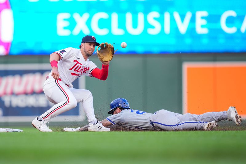 May 28, 2024; Minneapolis, Minnesota, USA; Kansas City Royals outfielder Kyle Isbel (28) steals second against the Minnesota Twins second base Kyle Farmer (12) in the third inning at Target Field. Mandatory Credit: Brad Rempel-USA TODAY Sports