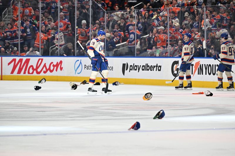 Dec 23, 2025; Edmonton, Alberta, CAN; Edmonton Oilers center Leon Draisaitl (29) skates among the hats as they celebrate a goal against the Calgary Flames during the third period at Rogers Place. Mandatory Credit: Walter Tychnowicz-Imagn Images