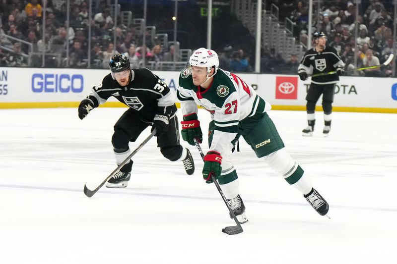 Apr 15, 2024; Los Angeles, California, USA; Minnesota Wild center Jacob Lucchini (27) shoots the puck against LA Kings defenseman Drew Doughty (8) in the first period at Crypto.com Arena. Mandatory Credit: Kirby Lee-USA TODAY Sports