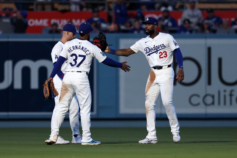 Jun 1, 2024; Los Angeles, California, USA;  Los Angeles Dodgers center fielder Andy Pages (44) and left fielder Teoscar Hernandez (37) and right fielder Jason Heyward (23)celebrate a victory after defeating the Colorado Rockies 4-1 at Dodger Stadium. Mandatory Credit: Kiyoshi Mio-USA TODAY Sports