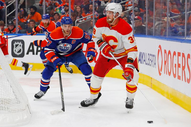 Sep 23, 2024; Edmonton, Alberta, CAN; Calgary Flames forward Antony Mantha (39) looks to make a pass in front of Edmonton Oilers forward Connor McDavid (97) during the second period at Rogers Place. Mandatory Credit: Perry Nelson-Imagn Images