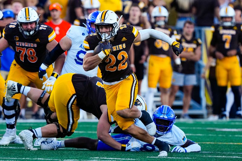 Sep 28, 2024; Laramie, Wyoming, USA; Wyoming Cowboys running back Sam Scott (22) runs against the Air Force Falcons during the first quarter at Jonah Field at War Memorial Stadium. Mandatory Credit: Troy Babbitt-Imagn Images
