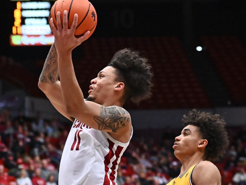 Jan 28, 2023; Pullman, Washington, USA; Washington State Cougars forward DJ Rodman (11) shoots the ball against Arizona State Sun Devils guard Austin Nunez (2) in the first half at Friel Court at Beasley Coliseum. Mandatory Credit: James Snook-USA TODAY Sports