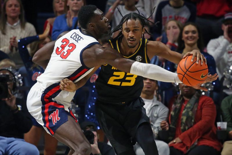 Feb 17, 2024; Oxford, Mississippi, USA; Missouri Tigers forward Aidan Shaw (23) handles the ball as Mississippi Rebels forward Moussa Cisse (33) defends during the second half at The Sandy and John Black Pavilion at Ole Miss. Mandatory Credit: Petre Thomas-USA TODAY Sports