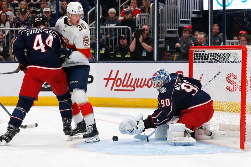 Oct 15, 2024; Columbus, Ohio, USA; Columbus Blue Jackets goalie Elvis Merzlikins (90) as Florida Panthers right wing Patrick Giles (36) looks for a rebound during the first period at Nationwide Arena. Mandatory Credit: Russell LaBounty-Imagn Images