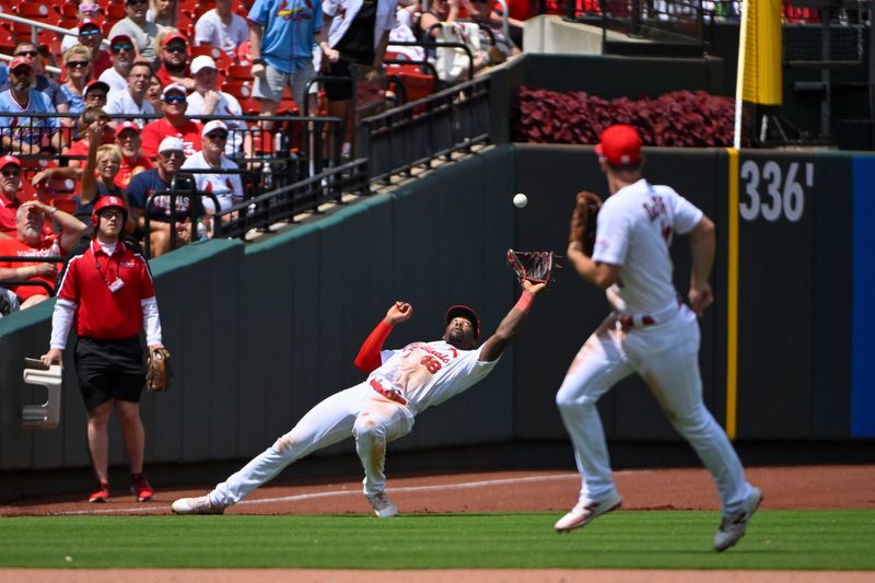 Jun 14, 2023; St. Louis, Missouri, USA;  St. Louis Cardinals left fielder Jordan Walker (18) slips but catches a fly ball against the San Francisco Giants during the ninth inning at Busch Stadium. Mandatory Credit: Jeff Curry-USA TODAY Sports