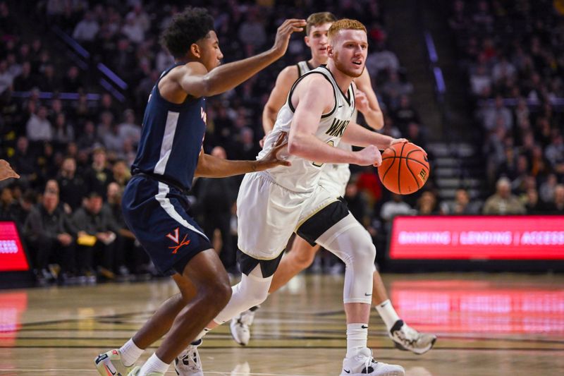 Jan 21, 2023; Winston-Salem, North Carolina, USA; Wake Forest Demon Deacons guard Cameron Hildreth (2) dribbles up court against Virginia Cavaliers guard Reece Beekman (2) during the first half at Lawrence Joel Veterans Memorial Coliseum. Mandatory Credit: William Howard-USA TODAY Sports