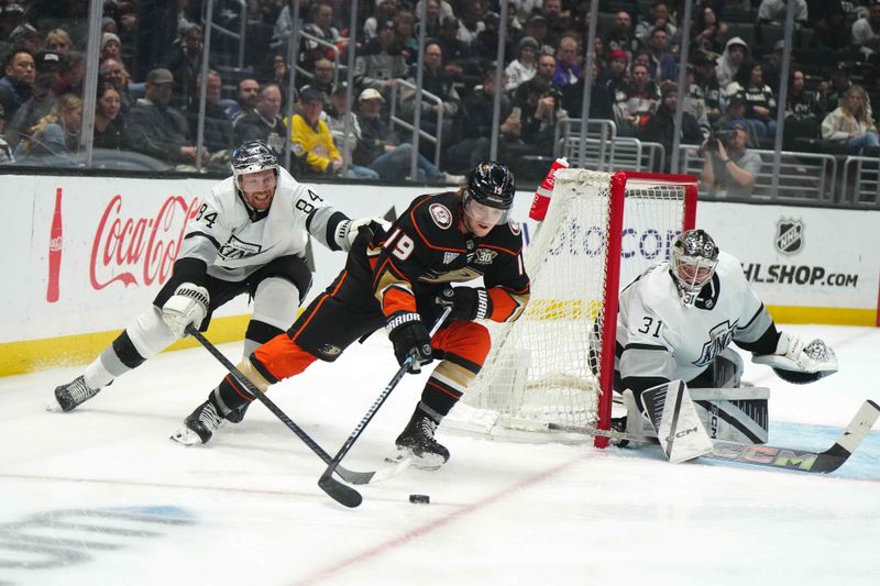 Apr 13, 2024; Los Angeles, California, USA; Anaheim Ducks right wing Troy Terry (19) skates with the puck against LA Kings defenseman Vladislav Gavrikov (84) and goaltender David Rittich (31) in the first period at Crypto.com Arena. Mandatory Credit: Kirby Lee-USA TODAY Sports