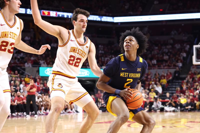 Jan 2, 2026; Ames, Iowa, USA;  Iowa State Cyclones forward Milan Momcilovic (22) defends West Virginia Mountaineers guard Amir Jenkins (2) during the second half at James H. Hilton Coliseum. Mandatory Credit: Reese Strickland-Imagn Images