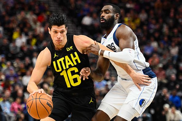 SALT LAKE CITY, UTAH - JANUARY 01: Simone Fontecchio #16 of the Utah Jazz drives past Tim Hardaway Jr. #10 of the Dallas Mavericks during the first half of a game at Delta Center on January 01, 2024 in Salt Lake City, Utah. NOTE TO USER: User expressly acknowledges and agrees that, by downloading and or using this photograph, User is consenting to the terms and conditions of the Getty Images License Agreement. (Photo by Alex Goodlett/Getty Images)