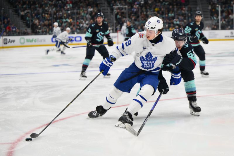 Jan 21, 2024; Seattle, Washington, USA; Toronto Maple Leafs left wing Tyler Bertuzzi (59) plays the puck while defended by Seattle Kraken left wing Tye Kartye (52) during the third period at Climate Pledge Arena. Mandatory Credit: Steven Bisig-USA TODAY Sports