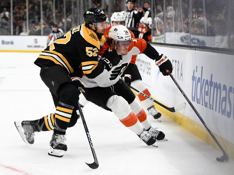 Oct 29, 2024; Boston, Massachusetts, USA; Philadelphia Flyers right wing Owen Tippett (74) controls the puck against Boston Bruins defenseman Andrew Peeke (52) during the second period at TD Garden. Mandatory Credit: Brian Fluharty-Imagn Images